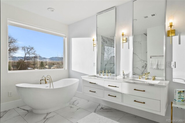 bathroom featuring a bathtub, a mountain view, and vanity