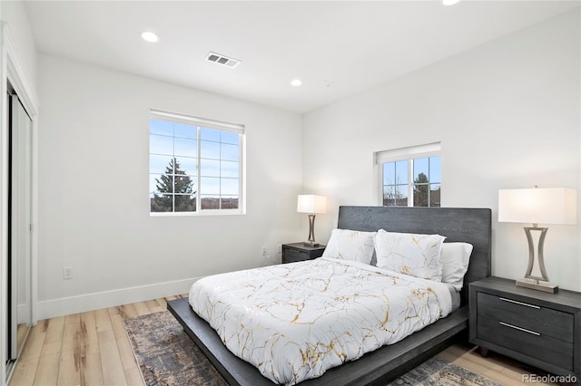 bedroom featuring a closet and light wood-type flooring