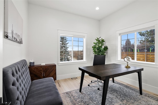 office area with recessed lighting, plenty of natural light, baseboards, and wood finished floors