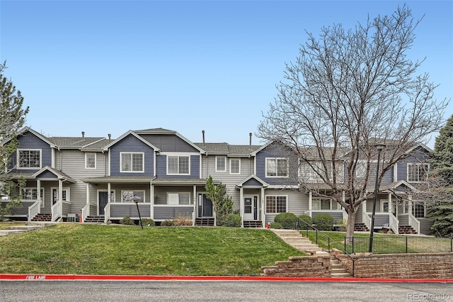 view of front of house with a front lawn and stairway