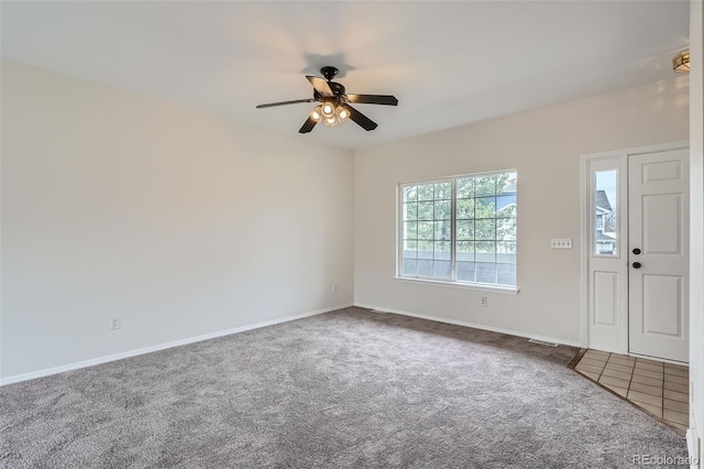 foyer featuring carpet floors, ceiling fan, and baseboards