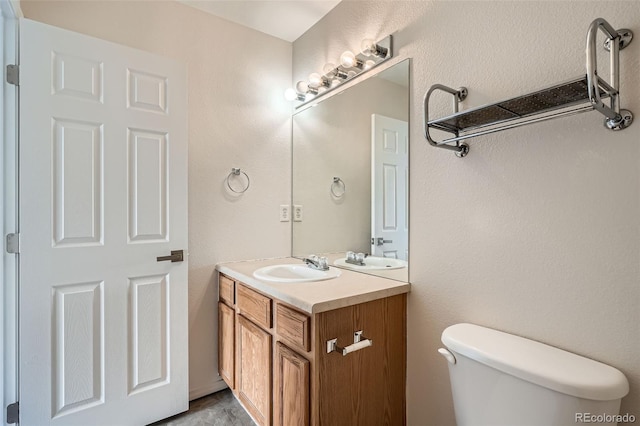 half bathroom featuring vanity and toilet
