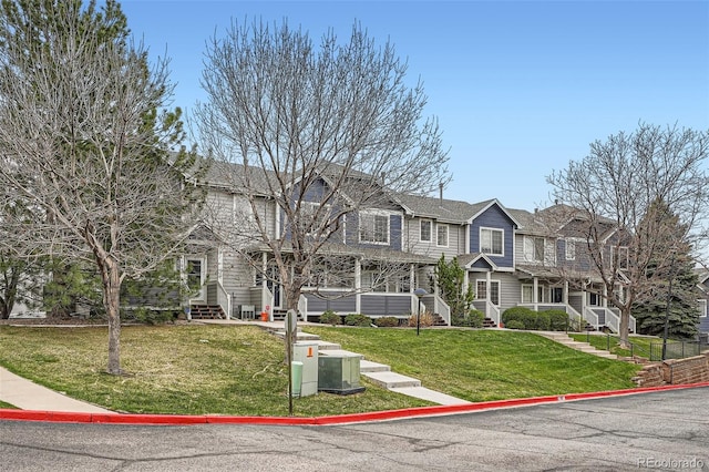 view of front of home featuring a front lawn and central AC unit
