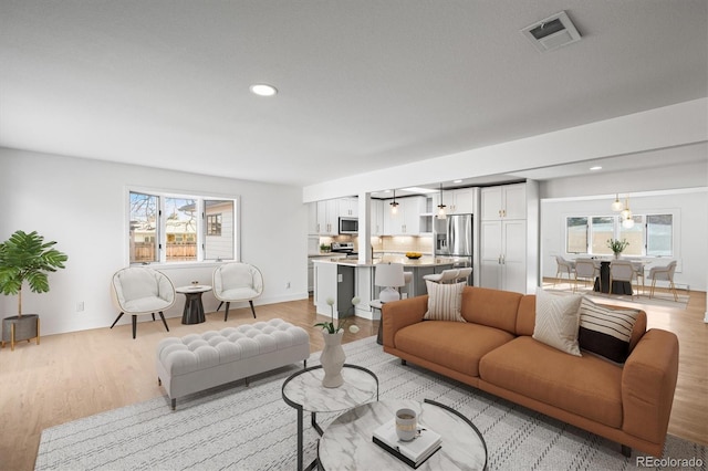 living room featuring light hardwood / wood-style flooring and a wealth of natural light