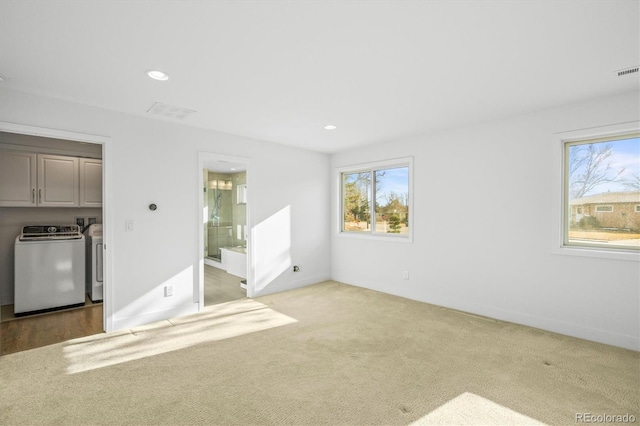 unfurnished bedroom featuring carpet, independent washer and dryer, and ensuite bath