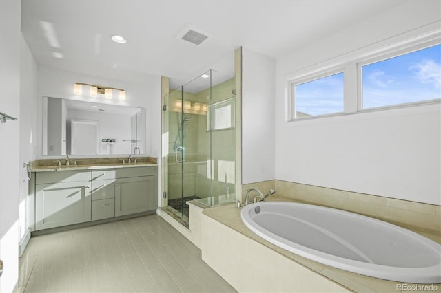 bathroom with tile patterned floors, vanity, and independent shower and bath