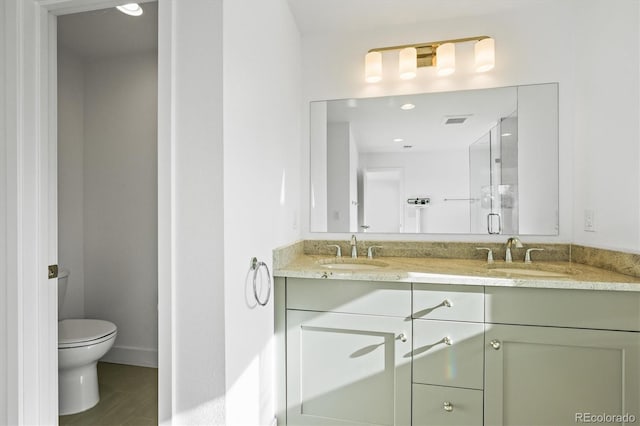 bathroom featuring vanity, toilet, and wood-type flooring