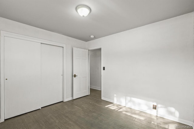 unfurnished bedroom featuring a closet and wood-type flooring