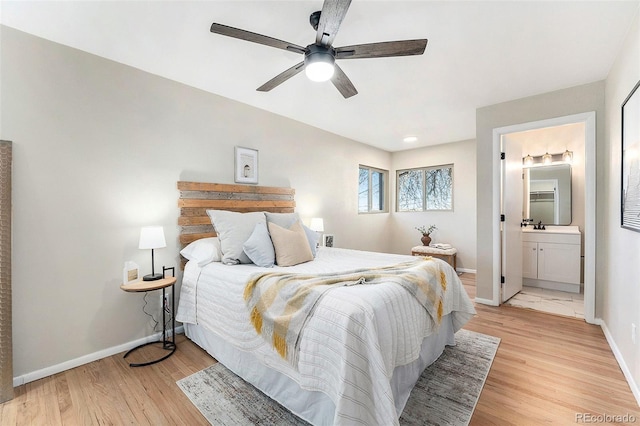 bedroom with sink, ensuite bath, ceiling fan, and light wood-type flooring