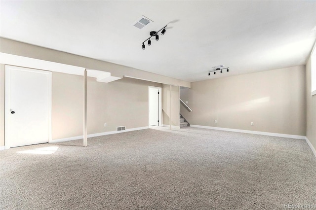 interior space with track lighting and carpet floors