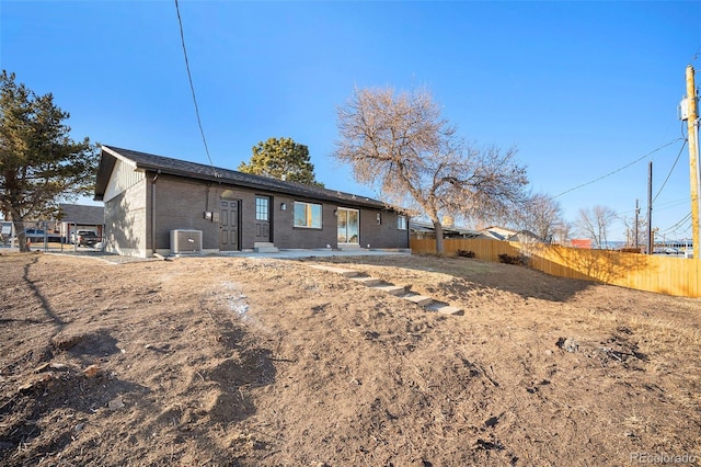 rear view of house featuring cooling unit