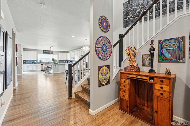 11744 Magnolia Dr, Thornton, CO 80233 - stairway featuring wood finished floors, baseboards, and recessed lighting