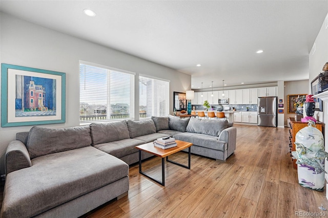 11744 Magnolia Dr, Thornton, CO 80233 - living room featuring light wood-type flooring and recessed lighting