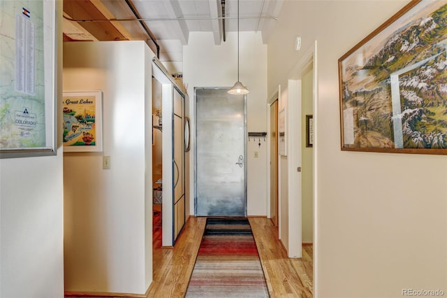 hallway with light hardwood / wood-style flooring