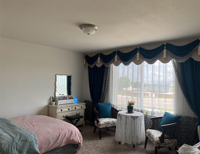 carpeted bedroom featuring a textured ceiling