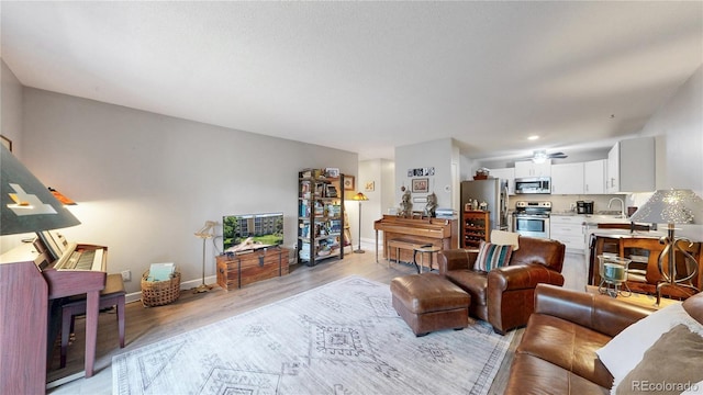 13626 E Bates Ave Unit 302, Aurora, CO 80014 - living room with light wood-type flooring and baseboards