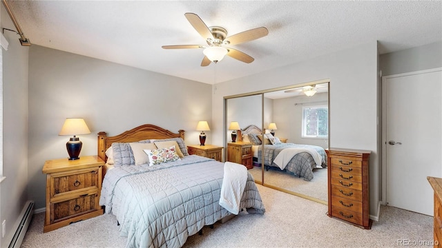 13626 E Bates Ave Unit 302, Aurora, CO 80014 - bedroom with a baseboard heating unit, carpet flooring, a closet, ceiling fan, and a textured ceiling
