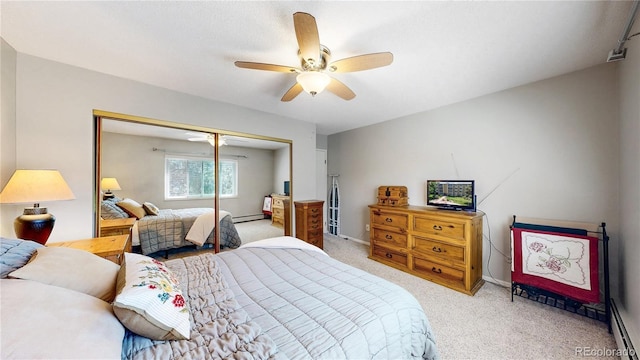 13626 E Bates Ave Unit 302, Aurora, CO 80014 - bedroom with light carpet, a closet, ceiling fan, and baseboard heating