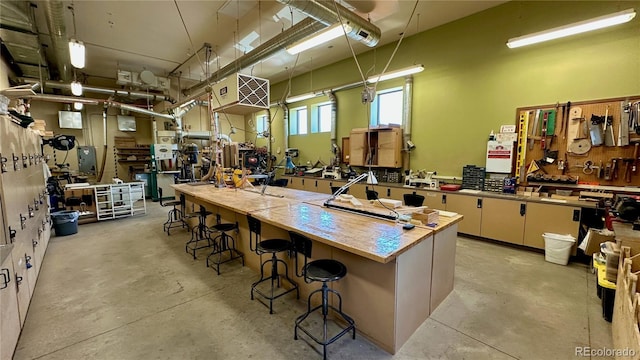 13626 E Bates Ave Unit 302, Aurora, CO 80014 - kitchen featuring concrete floors and a kitchen breakfast bar