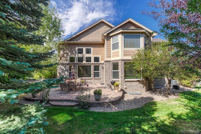 back of house with a patio, a lawn, and central air condition unit