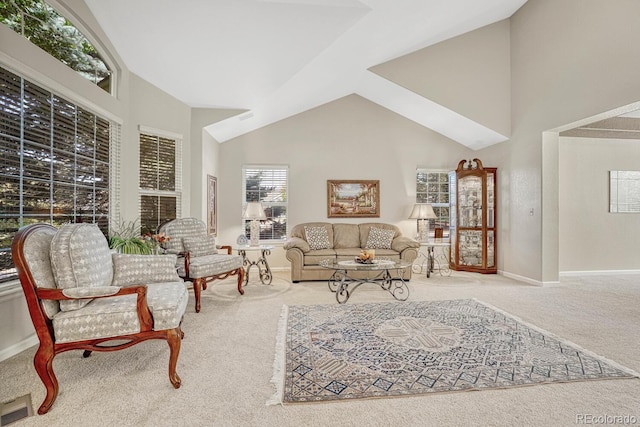 living room with high vaulted ceiling and carpet floors