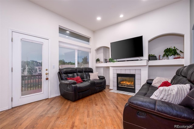 6245 Fencerail Hts, Colorado Springs, CO 80919 - living room featuring a fireplace, wood finished floors, recessed lighting, and built in shelves
