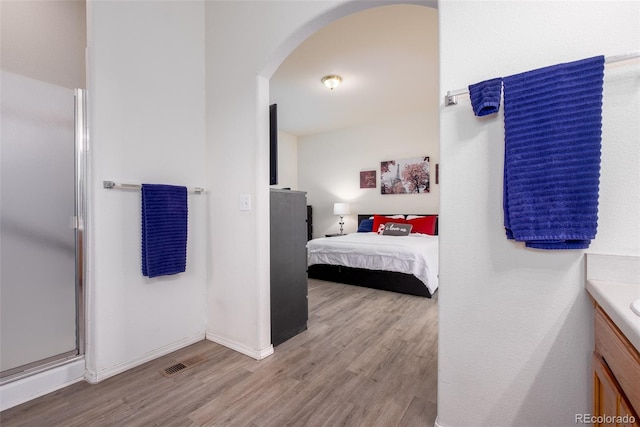 6245 Fencerail Hts, Colorado Springs, CO 80919 - full bath with vanity, wood finished floors, a shower stall, and ensuite bathroom