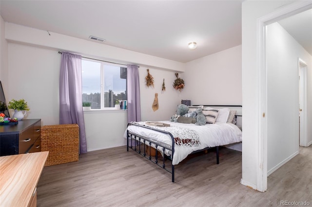 6245 Fencerail Hts, Colorado Springs, CO 80919 - bedroom featuring wood finished floors and baseboards