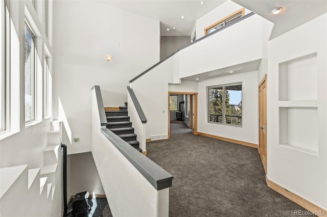 10508 Christopher Dr, Conifer, CO 80433 - stairway with carpet flooring, a high ceiling, and recessed lighting