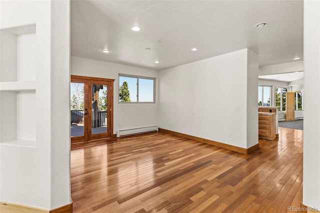 10508 Christopher Dr, Conifer, CO 80433 - spare room with baseboard heating, healthy amount of natural light, french doors, wood-type flooring, and recessed lighting