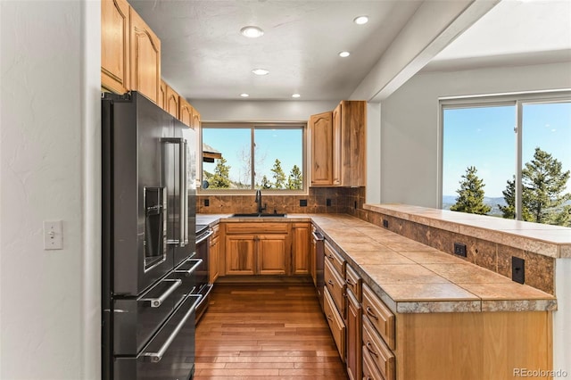 10508 Christopher Dr, Conifer, CO 80433 - kitchen featuring stainless steel appliances, a peninsula, dark wood-style floors, recessed lighting, and tasteful backsplash