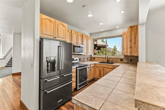 10508 Christopher Dr, Conifer, CO 80433 - kitchen with appliances with stainless steel finishes, dark wood-style flooring, backsplash, a peninsula, and recessed lighting