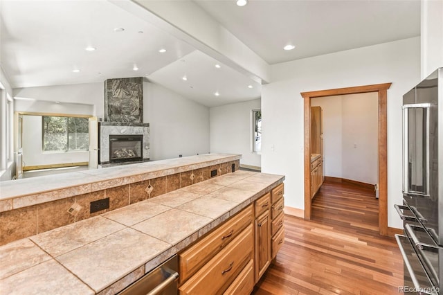 10508 Christopher Dr, Conifer, CO 80433 - kitchen with light wood-style floors, a large fireplace, recessed lighting, lofted ceiling, and open floor plan