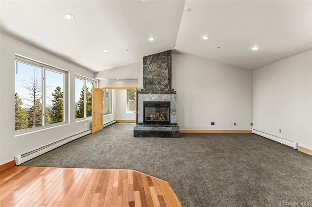 10508 Christopher Dr, Conifer, CO 80433 - unfurnished living room with a baseboard heating unit, recessed lighting, a large fireplace, lofted ceiling, and carpet floors