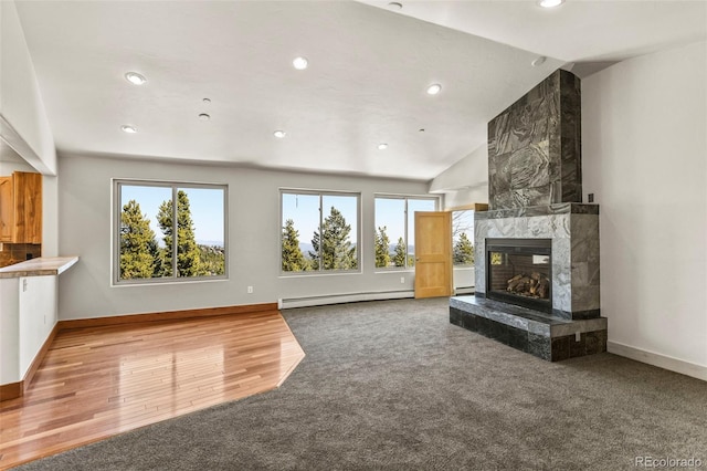 10508 Christopher Dr, Conifer, CO 80433 - unfurnished living room featuring a baseboard heating unit, recessed lighting, a high end fireplace, carpet, and vaulted ceiling