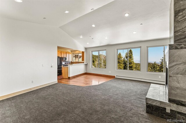 10508 Christopher Dr, Conifer, CO 80433 - unfurnished living room with a baseboard radiator, carpet, recessed lighting, and vaulted ceiling