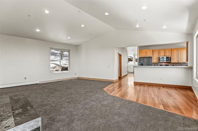 10508 Christopher Dr, Conifer, CO 80433 - unfurnished living room with vaulted ceiling, recessed lighting, a baseboard heating unit, light colored carpet, and light wood-style flooring