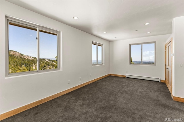 10508 Christopher Dr, Conifer, CO 80433 - spare room with a baseboard radiator, dark colored carpet, and recessed lighting