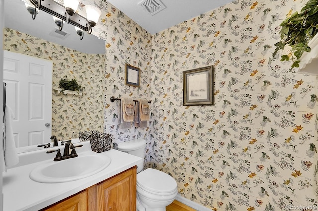 19447 E Bellisario Creek Dr, Parker, CO 80134 - bathroom with wallpapered walls, toilet, and vanity