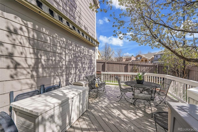 19447 E Bellisario Creek Dr, Parker, CO 80134 - wooden terrace with outdoor dining space, a fenced backyard, and a residential view