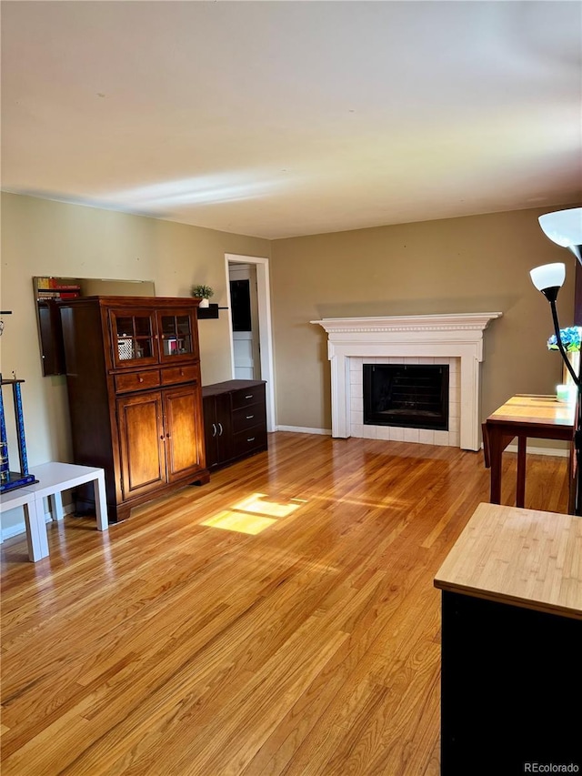 6616 S Lincoln St, Centennial, CO 80121 - unfurnished living room with light wood-style floors and a fireplace