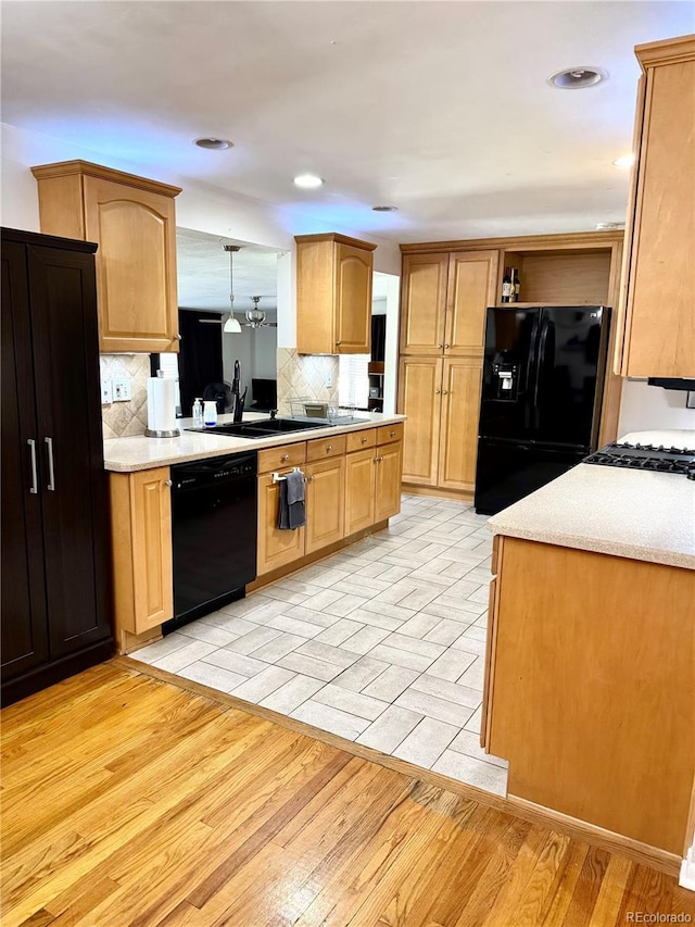 6616 S Lincoln St, Centennial, CO 80121 - kitchen featuring black appliances, tasteful backsplash, light countertops, light wood finished floors, and open shelves