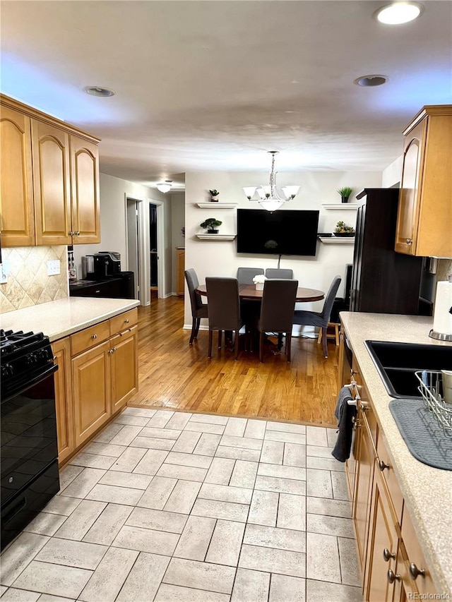 6616 S Lincoln St, Centennial, CO 80121 - kitchen featuring black appliances, light countertops, tasteful backsplash, a chandelier, and recessed lighting