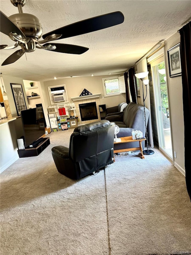 6616 S Lincoln St, Centennial, CO 80121 - carpeted living room featuring a textured ceiling, a ceiling fan, a fireplace, and an AC wall unit