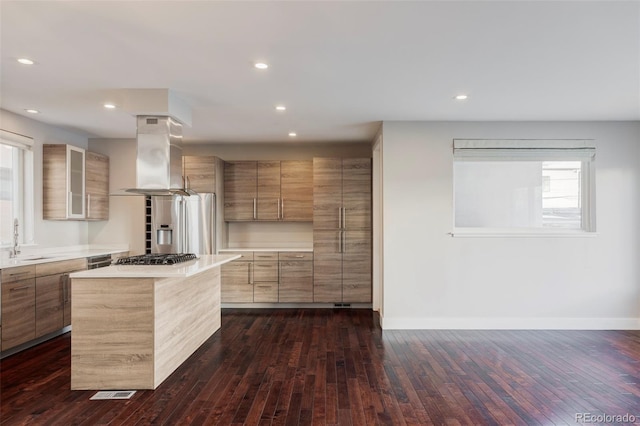 kitchen featuring island range hood, dark hardwood / wood-style floors, a center island, appliances with stainless steel finishes, and sink