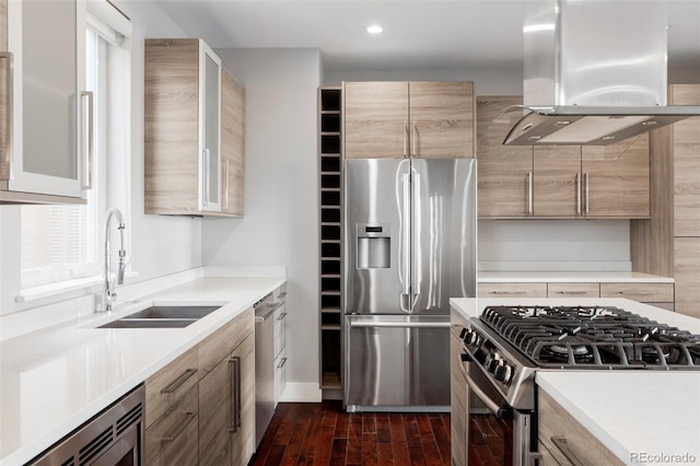 kitchen with sink, dark hardwood / wood-style floors, island exhaust hood, and appliances with stainless steel finishes