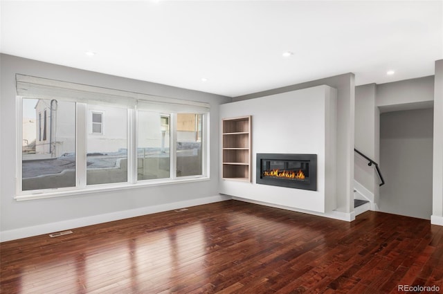 unfurnished living room with dark hardwood / wood-style floors