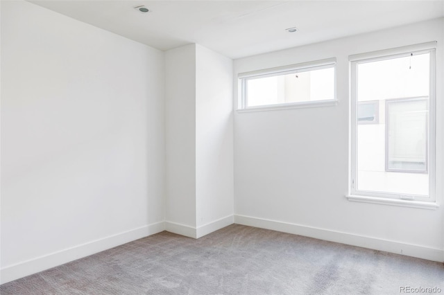 spare room featuring light colored carpet