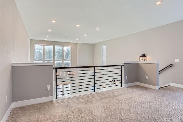 unfurnished living room featuring light colored carpet