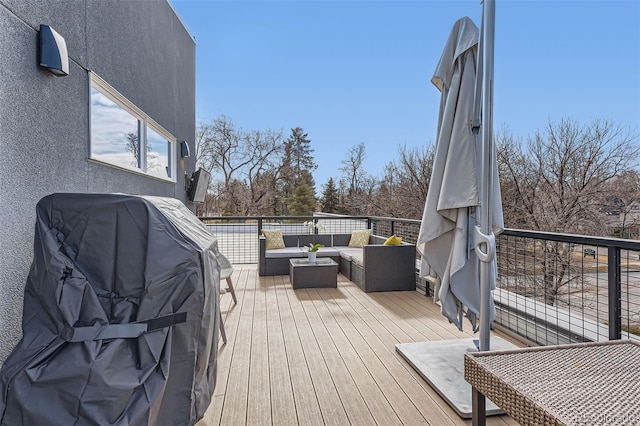 wooden deck featuring an outdoor hangout area and a grill